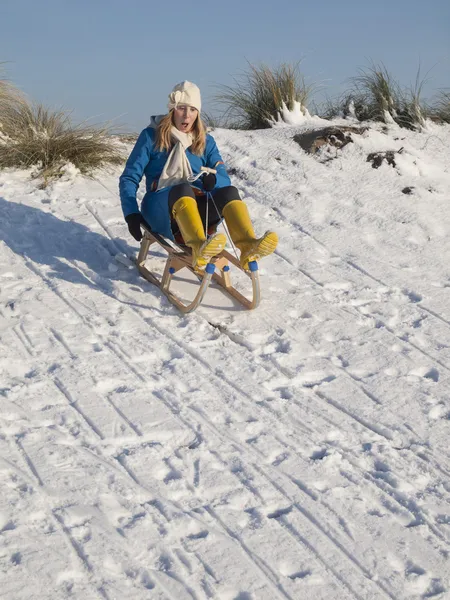 Woman sledging downhill — Stock Photo, Image