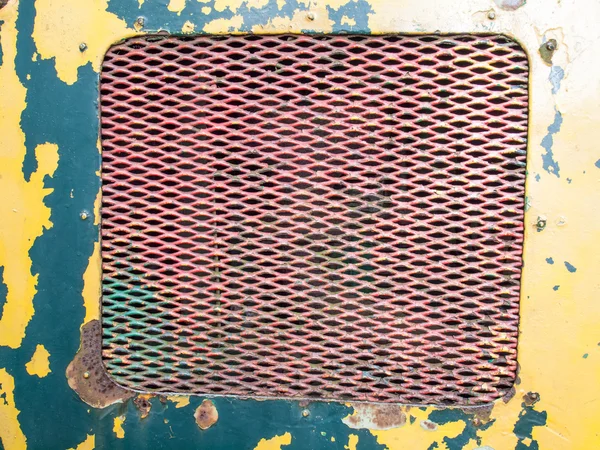 Flaking paint on rusty iron grill — Stock Photo, Image