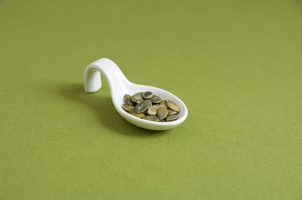 Close up view of organic Toasted Pumpkin Seeds in a spoon — Stock Photo, Image