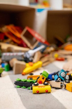Toys are scattered around the room. Wooden rails and a steam locomotive. Defocus. Educational games for young children. Kindergarten.