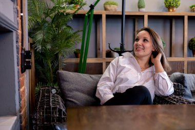 Kadın ofis çalışanı bir kafede oturuyor. Bir kadın portresi. Freelancer öğle yemeğini bekliyor.