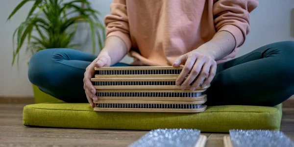 Yogi woman lays out sadhu boards with nails for group practice. Yoga practice. Girl in a good mood leads an active spiritual lifestyle to maintain harmony