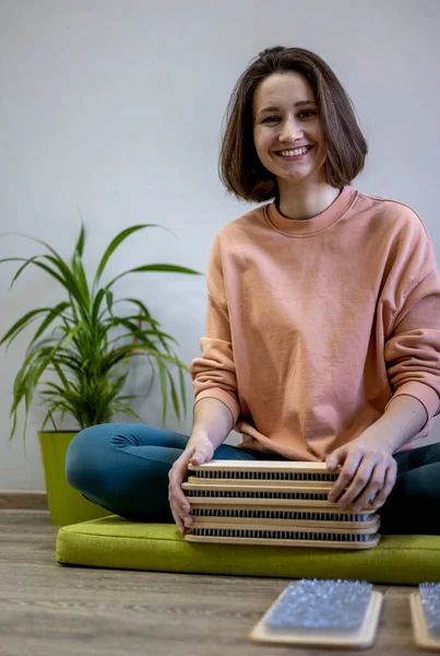 Yogi woman lays out sadhu boards with nails for group practice. Yoga practice. Girl in a good mood leads an active spiritual lifestyle to maintain harmony