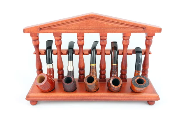 Collection of smoking pipes on wooden stand — Stock Photo, Image