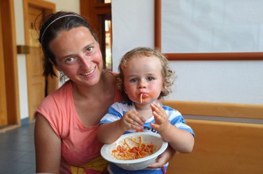 kadın ve spagetti yiyen çocuk