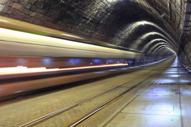 A tram disappearing into a tunnel clipart