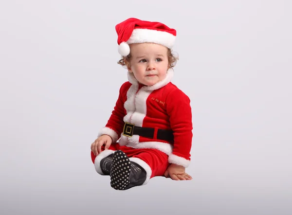 Miúdo bonito em roupas de Papai Noel — Fotografia de Stock