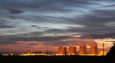 Nuclear power plant by night clipart