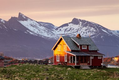 Norway house with mountain in background clipart