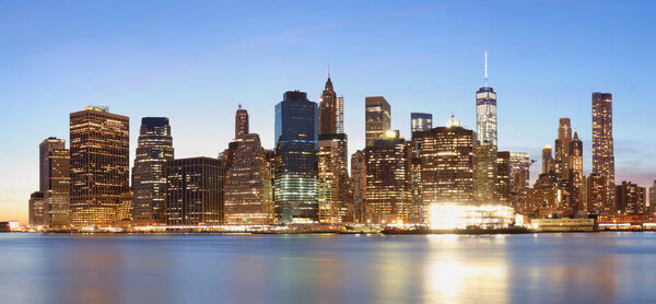 New York panorama with Brooklyn bridge at night, USA