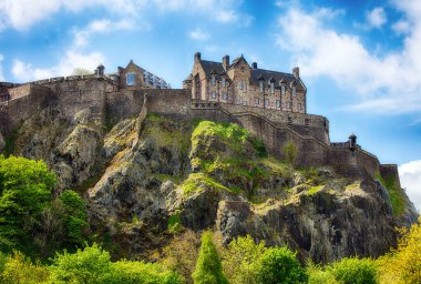 Castle hill in Edinburgh with green grass and blue sky, Scotland, UK