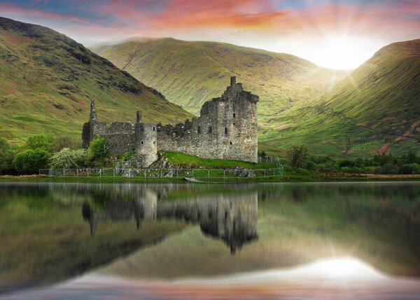 Scotland landscape - Kilchurn Castle with reflection in water at dramatic sunset