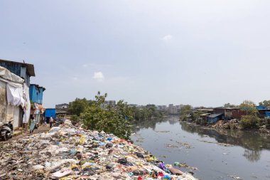 Mumbai,India-7-28-2022: Garbage dumped on the banks on Meeti river sweet river near Kalina area.
