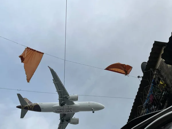 Mumbai,India-07-29-2022: Aircrafts flying dangerously close to the slums hutments area in kurla area on the path of airport landing
