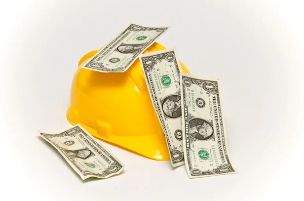 Helmet and money in dollars. — Stock Photo, Image