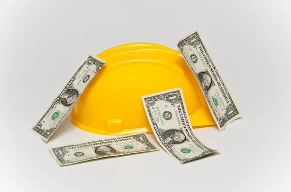 Helmet and money in dollars. — Stock Photo, Image