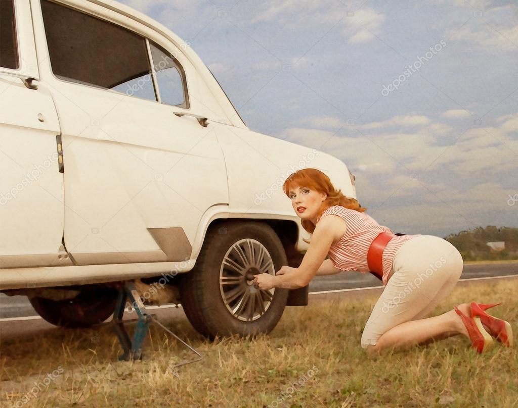 Woman Changing a Tire — Stock Photo © Johnovich 18089527