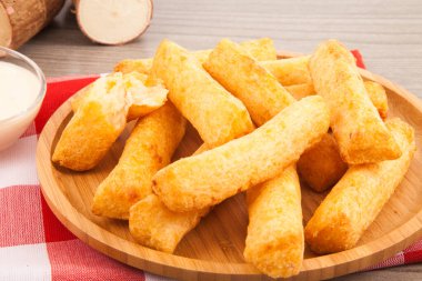 Ahşap arka planda kavrulmuş manyok..