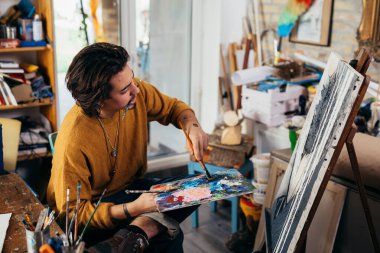 Atölyesinde çalışan bir ressam.