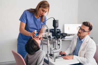 Küçük çocuk klinikte görüş kontrolü yaptırıyor.