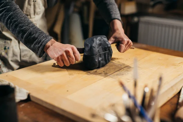 Kadın atölyesinde çömlek yapıyor.