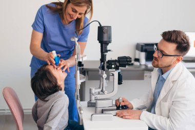 little boy has eye examine in clinic