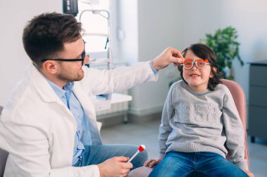 little boy has eye examine in clinic