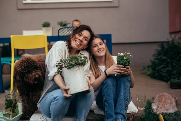 Happy Mother Daughter Holding Plants Looking Camera — Stok fotoğraf