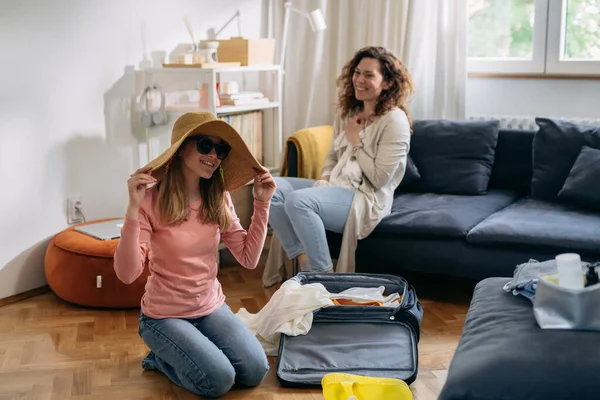 mother and daughter feels excited while packing bags for summer vacation