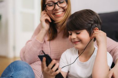 caucasian boy listening to music on headphones