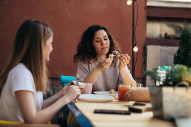 mother and daughter breakfast together at home