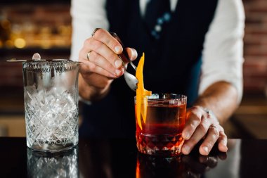 close up of barman decorating cocktail