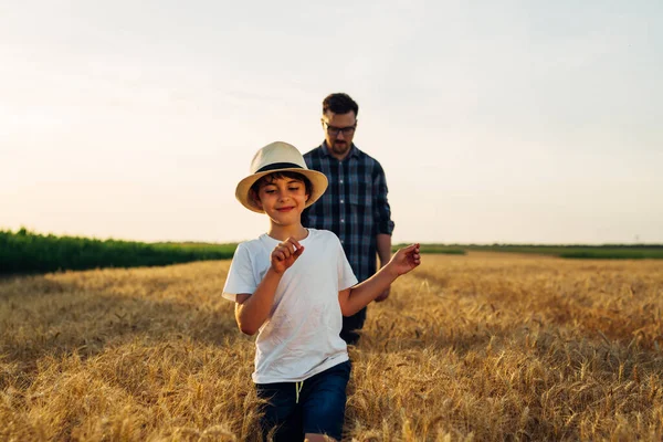 Young Boy Walks Wheat Field His Father —  Fotos de Stock