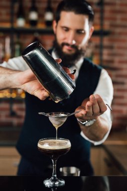 close up of barman preparing espresso martini cocktail