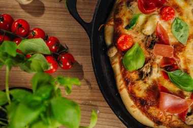 close up top view of homemade pizza on wooden table