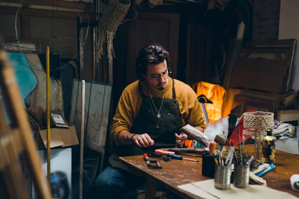 man painting in his atelier