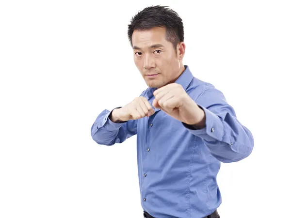 Asian businessman showing karate move — Stock Photo, Image