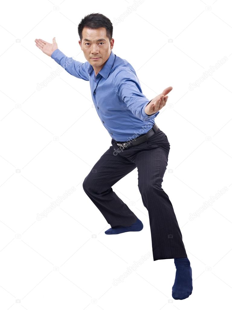 Asian businessman showing karate move
