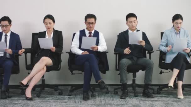 グループアジアの執行役員面接を待っている椅子に座って求職者 — ストック動画