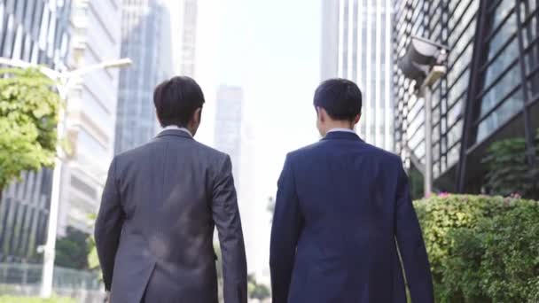 Rear View Two Asian Businessmen Talking While Walking Street Modern — Stock Video