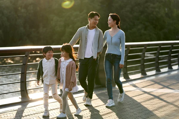 Щаслива Азіатська Сім Двома Дітьми Йдуть Пішохідним Мостом Міському Парку — стокове фото