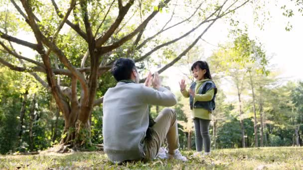 アジア系の父親と娘は公園でアウトドアを楽しんでいます — ストック動画