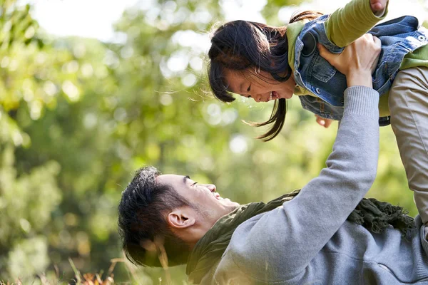 Asiático Padre Acostado Espalda Hierba Tener Bueno Tiempo Levantando Hija — Foto de Stock