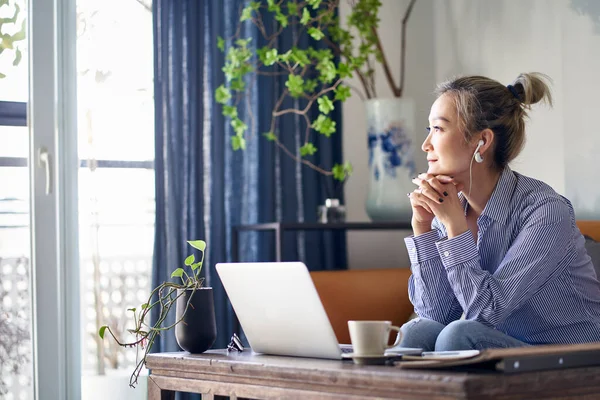 Mature Professional Asian Woman Working Home Looking Away Thinking — Foto Stock