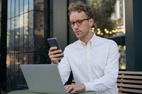 Pensive Businessman Using Laptop Holding Mobile Phone Looking Digital Screen — Stock Photo, Image