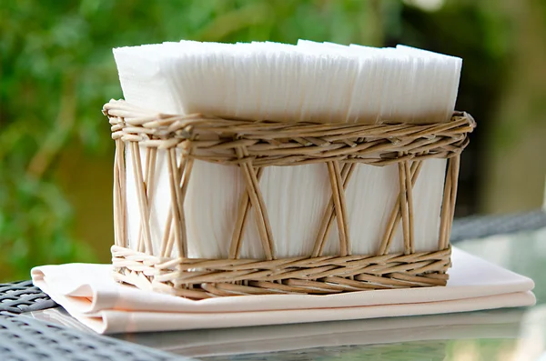 White napkins in holder on glass table — Stock Photo, Image