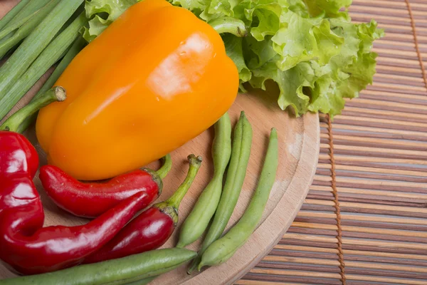 Fresh vegetables on board and bamboo — Stock Photo, Image