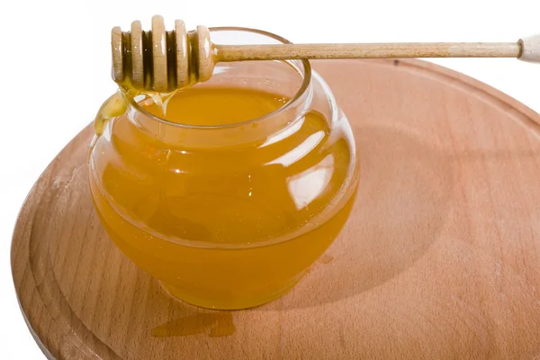 Honey in the stick of honey on the bowl — Stock Photo, Image