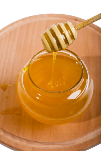 Honey in the stick of honey on the bowl, isolated — Stock Photo, Image