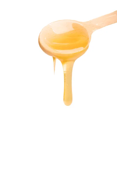 Honey flowing from the spoon — Stock Photo, Image